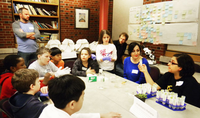 Norma A. Castro-Guerrero with elementary school children learning how to grow plants using hydroponics